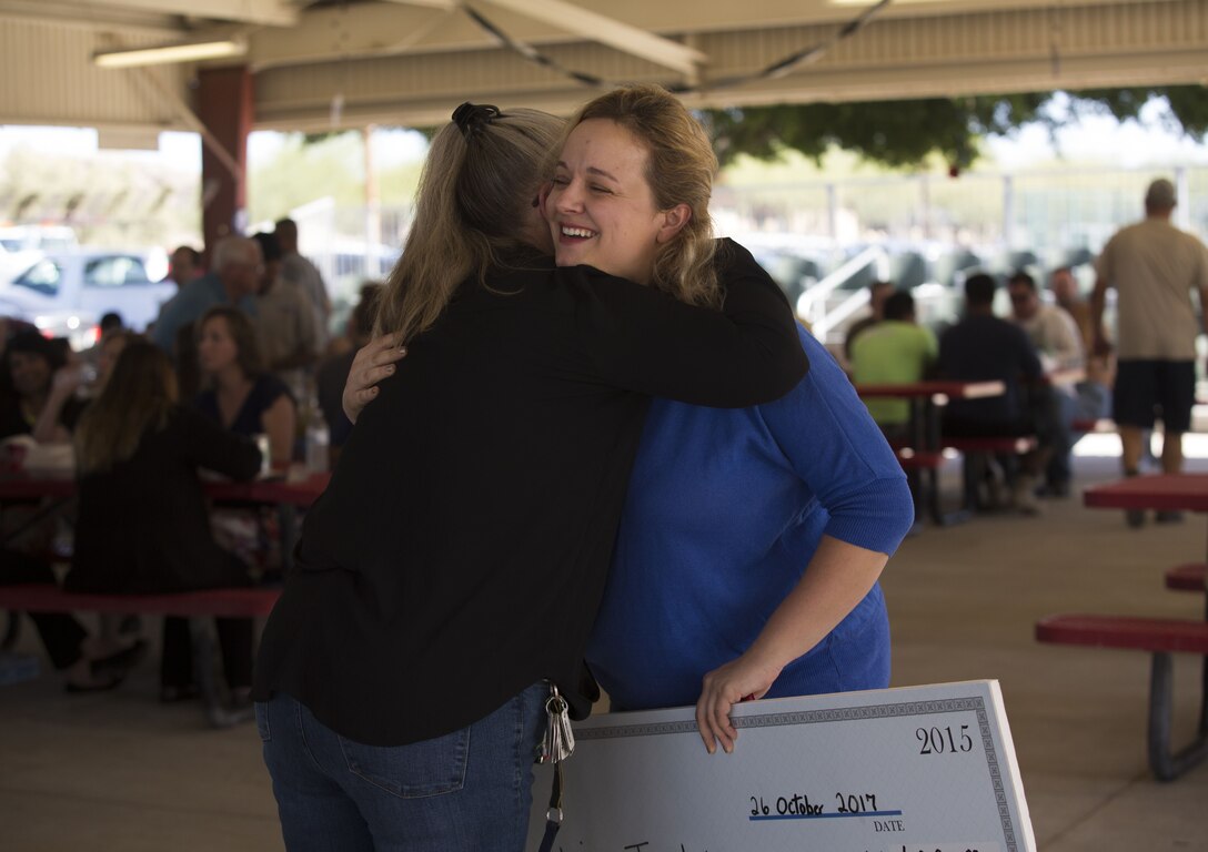 Members of the Civilian Employee Welfare Recreation Association celebrate the Marine Corps Air Station Yuma 2017 Employee of the Year at the MCAS Yuma, Ariz., Picnic Pavilion Oct. 26, 2017. This annual event is organized in appreciation of the civilian employees on the station. (U.S. Marine Corps photo by Lance Cpl. Sabrina Candiaflores)
