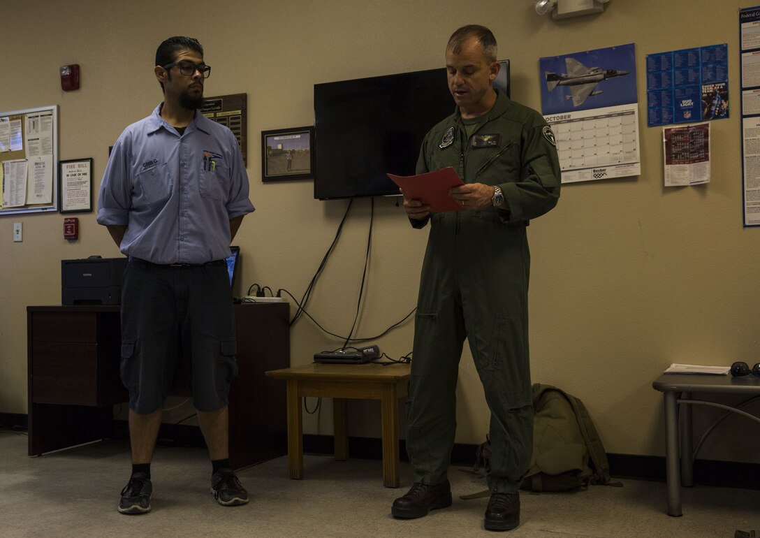 U.S. Marine Corps Col. James B. Wellons, the commanding officer of Marine Aviation Weapons and Tactics Squadron (MAWTS) One recognizes Cristobal Corona, a driver systems operator who served as a dispatcher officer for the Fuel Branch during Weapons and Tactics Instructor Course 1-18 at the Fuel Brance office on Marine Corps Air Station Yuma, Ariz., Oct. 26, 2017. The Fuel Branch supported MAWTS-1 in their efforts to provide standardized advanced tactical training during Weapons and Tactics Instructor courses twice a year in addition to daily routines and supporting other squadrons visiting or on station. (U.S. Marine Corps photo taken by Cpl. Christian Cachola)