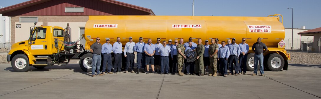 U.S. Marine Corps Col. James B. Wellons, the Commanding Officer of Marine Aviation Weapons and Tactics Squadron (MAWTS) One, and Sgt. Maj. Thomas W. Foster, the sergeant major of MAWTS-1, take a group photo outside the Fuel Branch office on Marine Corps Air Station Yuma, Ariz., Oct. 26, 2017. Station Fuel supported MAWTS-1 in their efforts to provide standardized advanced tactical training during Weapons and Tactics Instructor course twice a year in addition to their daily routines and supporting other squadrons visiting or on station. (U.S. Marine Corps photo taken by Lance Cpl. Hanna L. Powell)