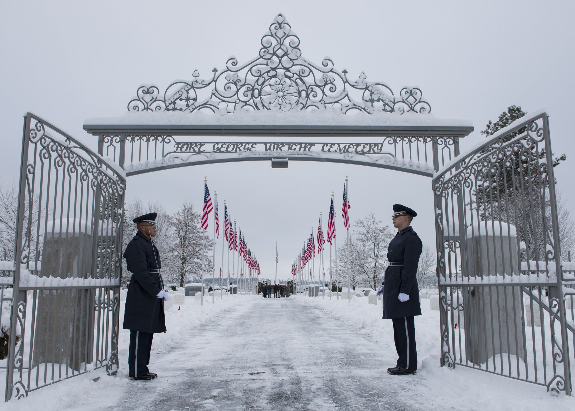 Two members of the Fairchild Air Force Base Honor Guard stand at the entrance during an annual wreath laying ceremony at Fort George Wright Cemetery, Washington, Dec. 16, 2017. The Honor Guard is an ever-present part of military ceremonies, serving to uphold the traditions of honoring those that serve. (U.S. Air Force photo/Senior Airman Ryan Lackey)