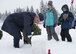 Maj. Shawn Bishop, 92nd Air Refueling Wing chaplain, reads the name of a gravestone during an annual wreath laying ceremony at Fort George Wright Cemetery, Washington, Dec. 16, 2017. Fairchild service members brave harsh winter conditions each year to pay honors to fallen veterans at the cemetery. (U.S. Air Force photo/Senior Airman Ryan Lackey)