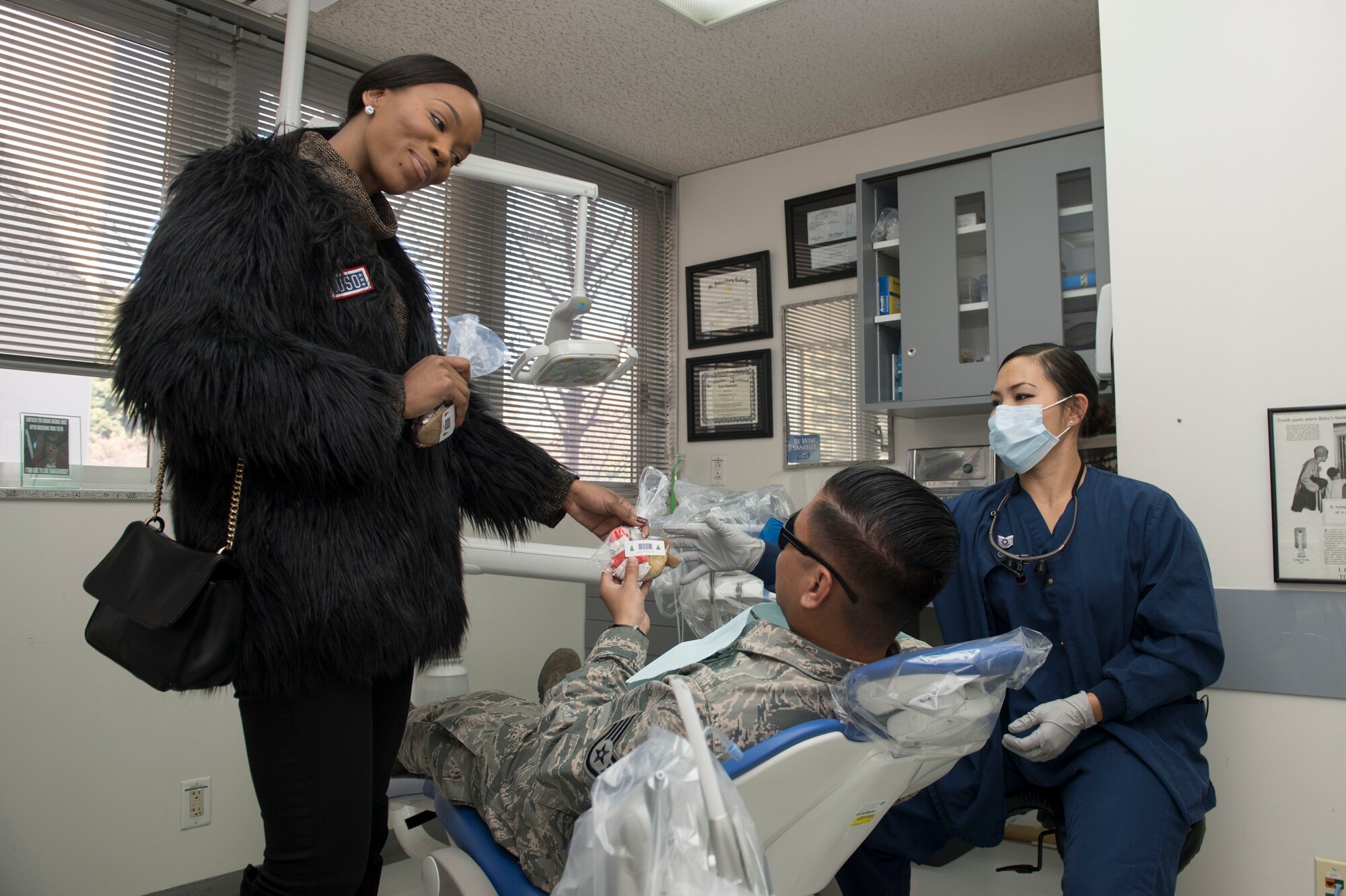 Kiyana Kemp, United Service Organizations Yokota center manager, passes out cookies to Airmen for Cookie Caravan, Dec. 13, 2017, Yokota Air Base, Japan.