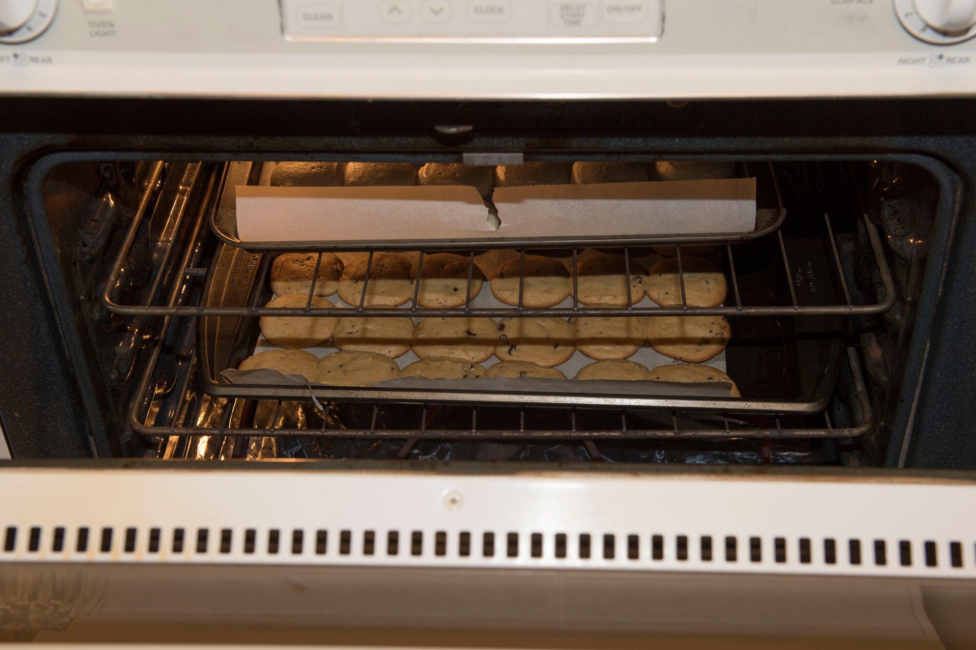 Golden brown chocolate chip cookies sit in the oven prior to being donated to the United Service Organizations Yokota’s Cookie Caravan, Dec. 13, 2017, at Yokota Air Base, Japan.