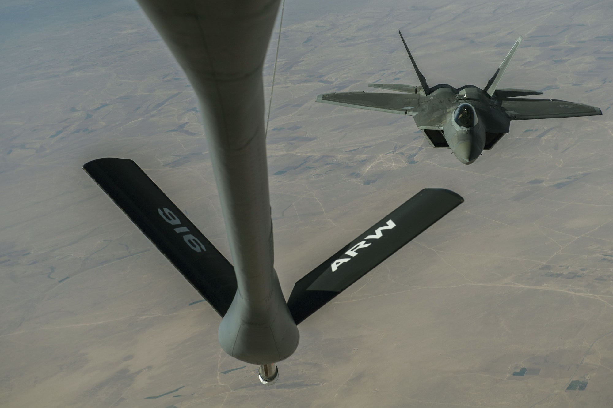 A U.S. Air Force F-22 Raptor receives fuel from a KC-135 Stratotanker assigned to the 447th Air Expeditionary Group during a refueling mission over Syria, Dec. 1, 2017.