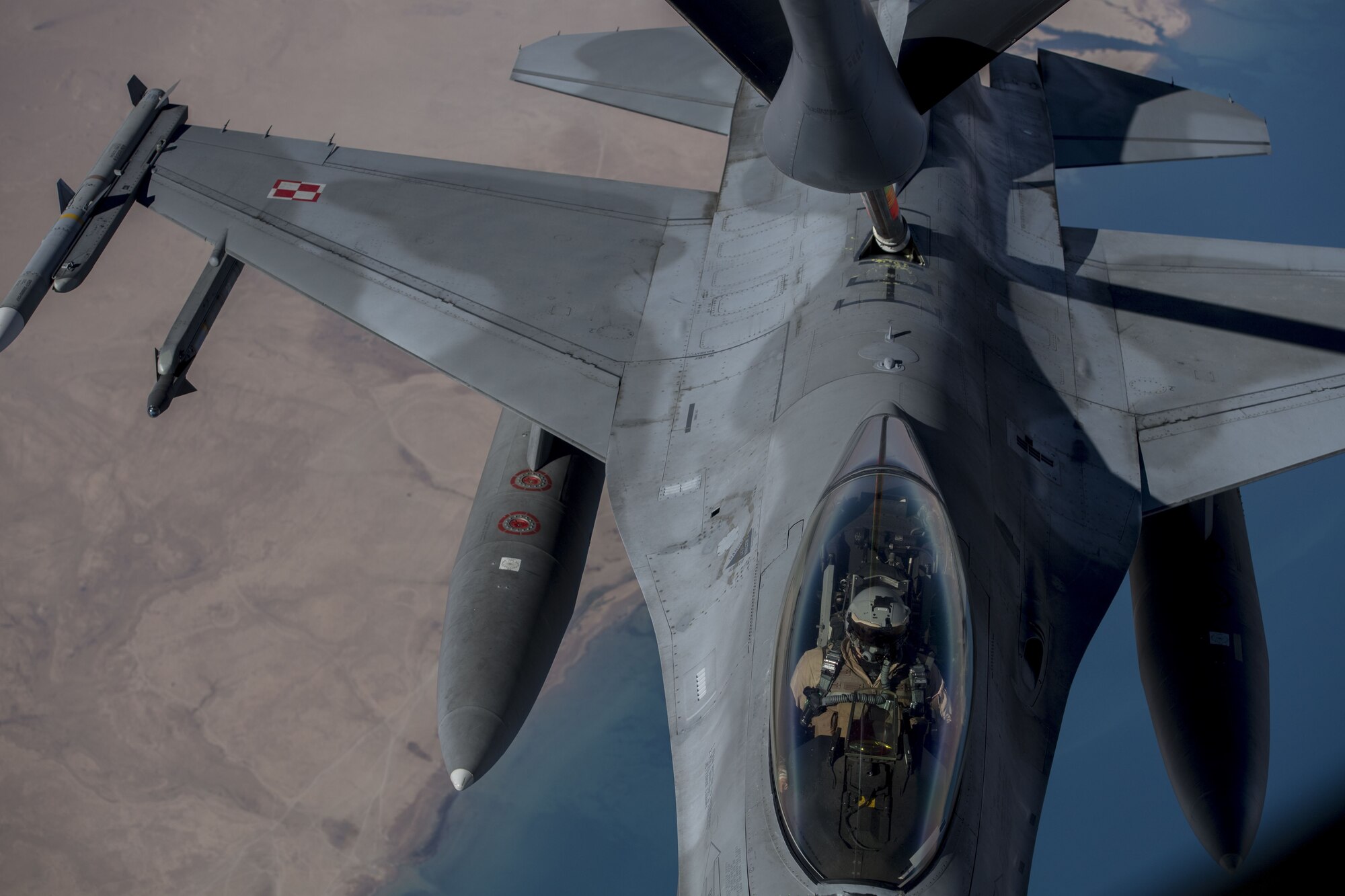 A Polish F-16 Fighting Falcon pilot maneuvers his aircraft into position to receive fuel from a KC-135 Stratotanker assigned to the 447th Air Expeditionary Group during a refueling mission over Syria, Dec. 1, 2017. The Polish Air Force is a military branch of the Polish Armed Forces, as of 2014 it consisted of around 16,425 military personnel and around 475 aircraft distributed among 10 bases throughout Poland. (U.S. Air Force photo by Staff Sgt. Paul Labbe)