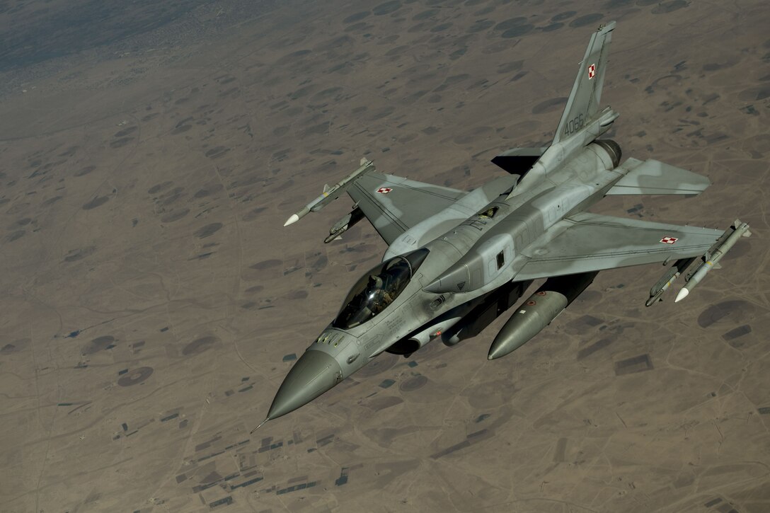 A Polish F-16 Fighting Falcon departs to continue a mission after receiving fuel from a KC-135 Stratotanker assigned to the 447th Air Expeditionary Group over Syria, Dec. 1, 2017.