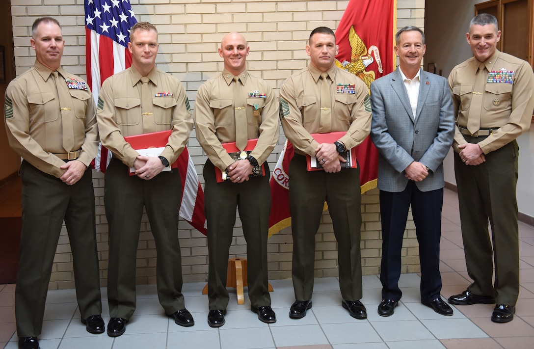 Brig. Gen. Jason Bohm, (Far right), Sgt. Maj. Jeffrey Monssen (Far left) and retired Lt. Gen. William Faulkner pose with the winners of the Training Command’s Commanding General’s Writing Competition at Marine Corps Base Quantice, Virginia, Dec. 14, 2017. Capt. Kyle Tucker-Davis, GySgt. William Callen and Sgt. Matthew Harrison, won 1st, 2nd and 3rd place, respectively. Bohm is the commanding general for Training Command. Monssen is the Sergeant Major for Training Command.
