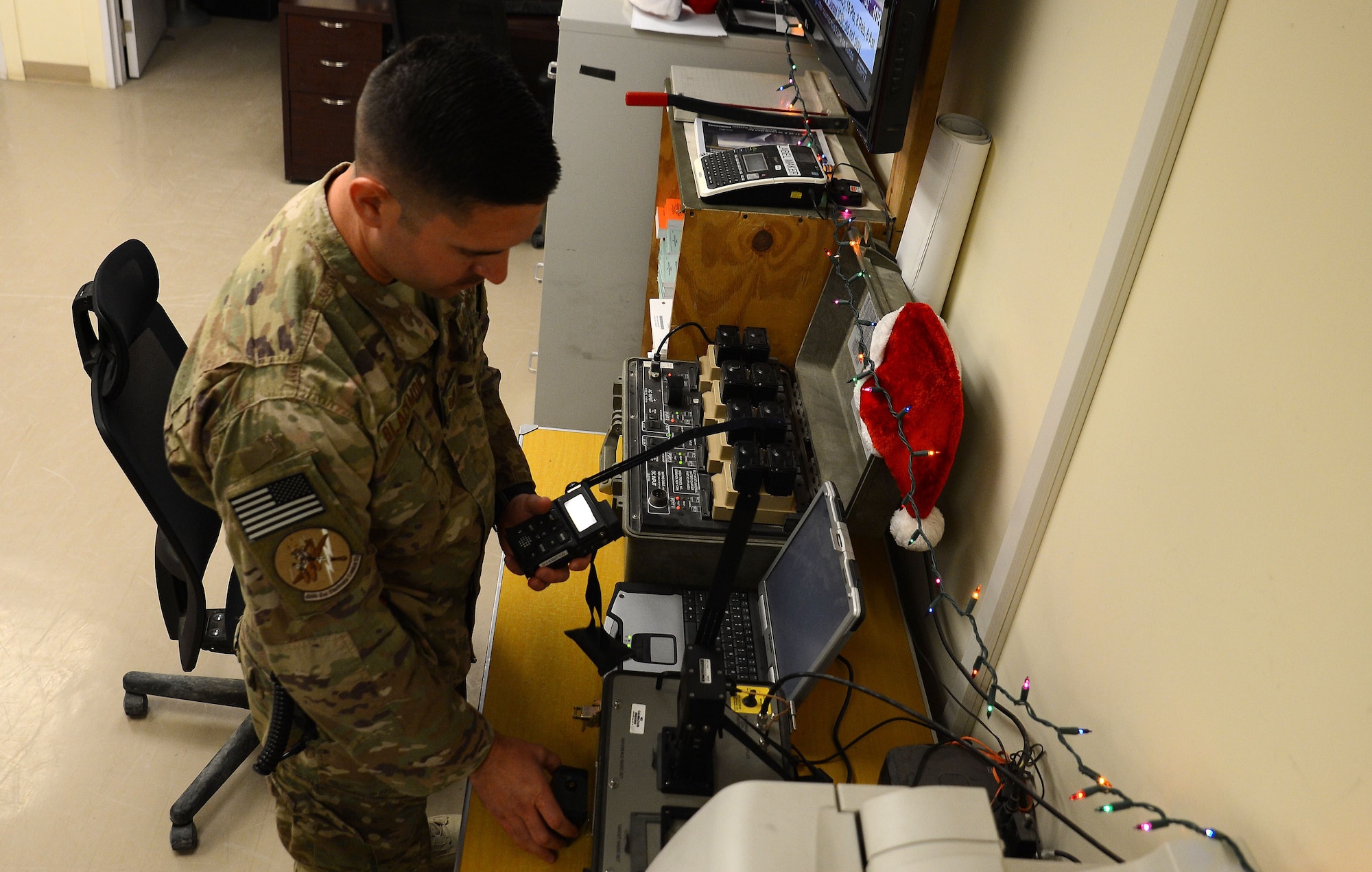 Tech. Sgt. Andrew Blackmon, 430th Expeditionary Electronic Combat Squadron aircrew flight equipment technician, checks the survival radios Nov. 28, 2017 at Kandahar Airfield, Afghanistan.