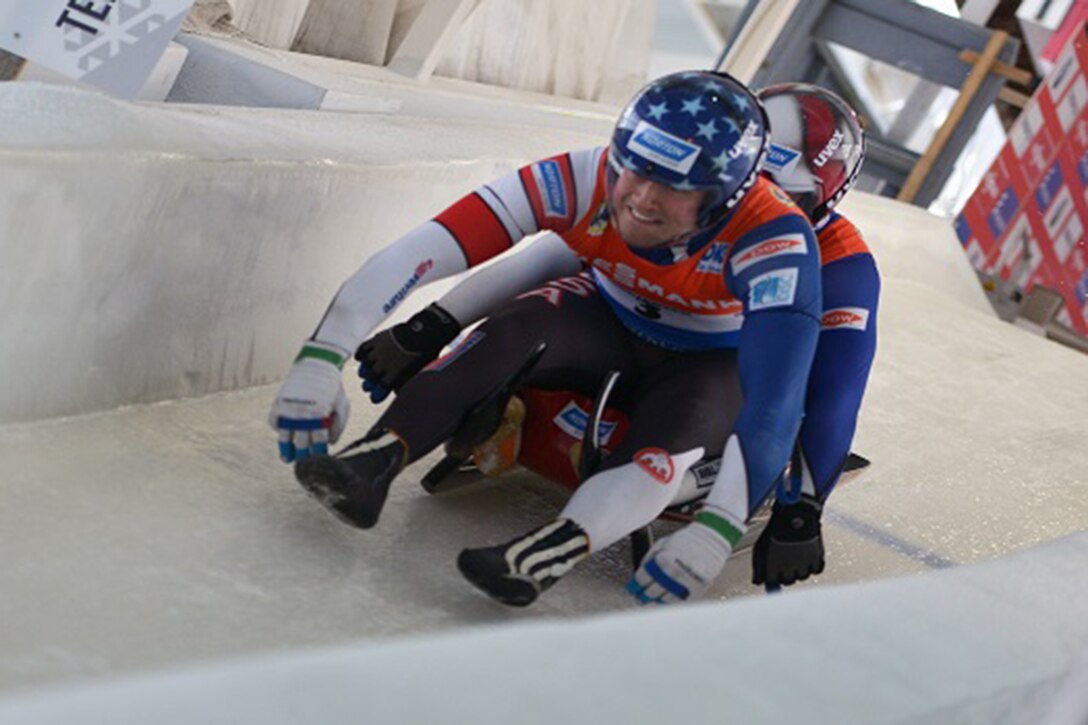 Two soldiers take part in a luge competition.