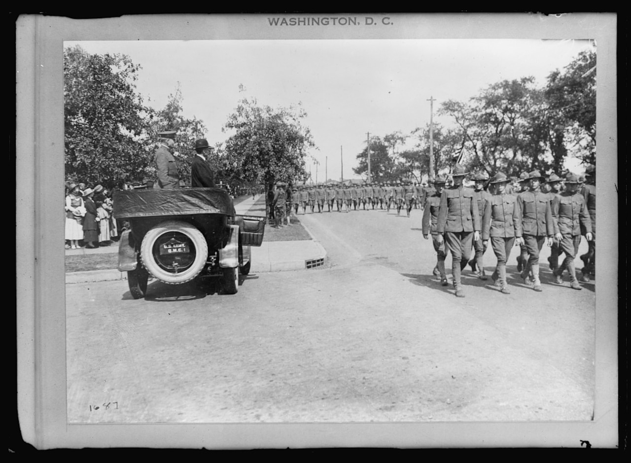 Secretary of War Newton D. Baker and Army Gen. William A. Mann, commander of the 42nd Infantry Division, review the division at Camp Mills, N.Y., in September or October 1917, during preparations for the division’s departure to France. Library of Congress photo