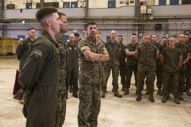 Lt. Col. Kenneth Phelps, the commanding officer of Marine Unmanned Aerial Vehicle Squadron 3, recognizes Sgt. Joseph Latsch and Sgt. Ethan Mintus, unmanned aerial system operators with VMU-3, after an award ceremony at Hangar 103, Marine Corps Air Station Kaneohe Bay, Dec. 11, 2017. Latsch and Mintus are the first UAS operators in the Marine Corps to receive a Navy and Marine Corps Achievement Medal with the newly authorized Remote Impact “R” Device for providing support during combat operations.