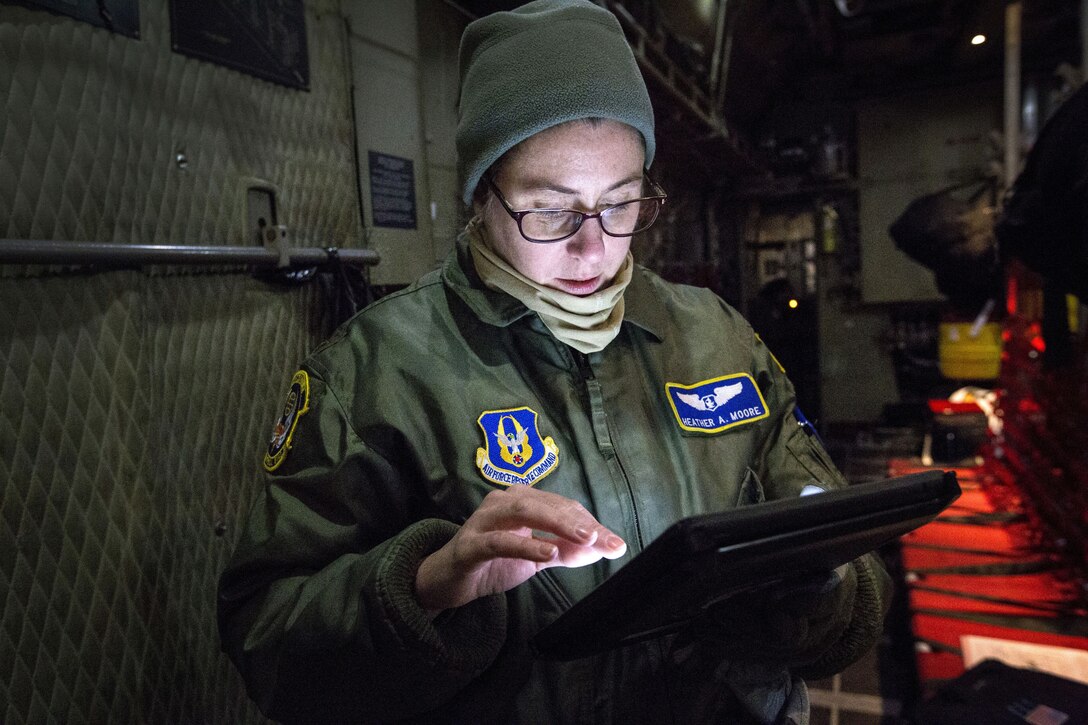 An airman reviews a checklist before departure of mission training.