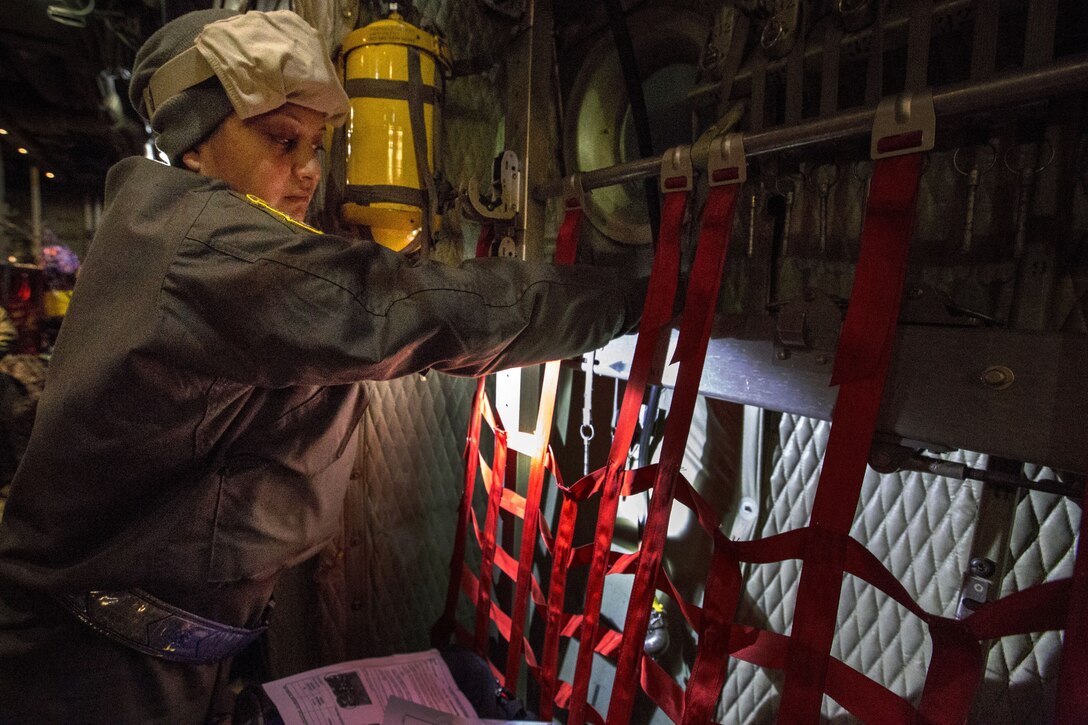 An airman sets up her station before departure.