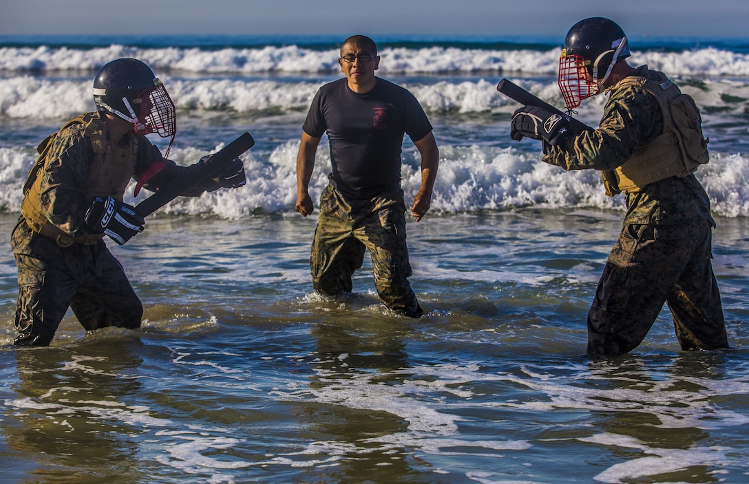 U.S. Marines with Headquarters Regiment, 1st Marine Logistics Group, prepare to practice “weapons of opportunity” techniques during a field exercise at Camp Pendleton, Calif., Dec. 14, 2017. The Marines were participating in a Martial Arts Instructors course to earn their instructor tabs, allowing them to teach MCMAP to other Marines in the future.