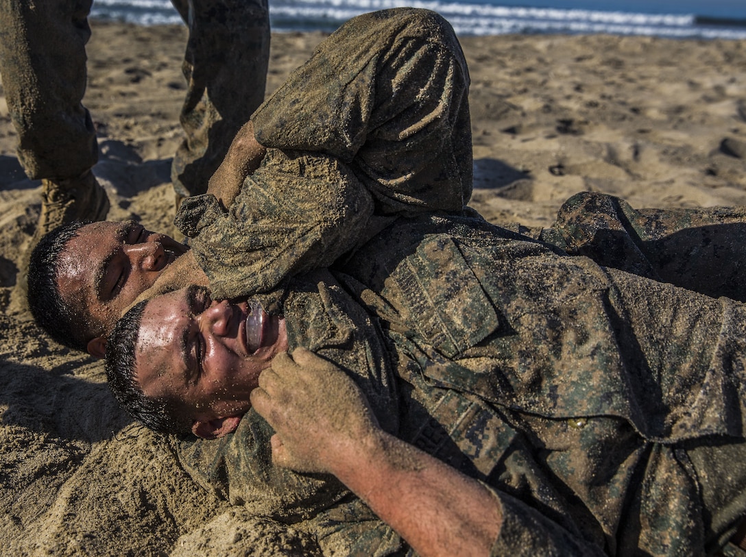 U.S. Marines with Headquarters Regiment, 1st Marine Logistics Group, practice grappling during a field exercise at Camp Pendleton Calif., Dec. 14, 2017. The Marines were participating in a Martial Arts Instructors course to earn their instructor tabs, allowing them to teach MCMAP to other Marines in the future.