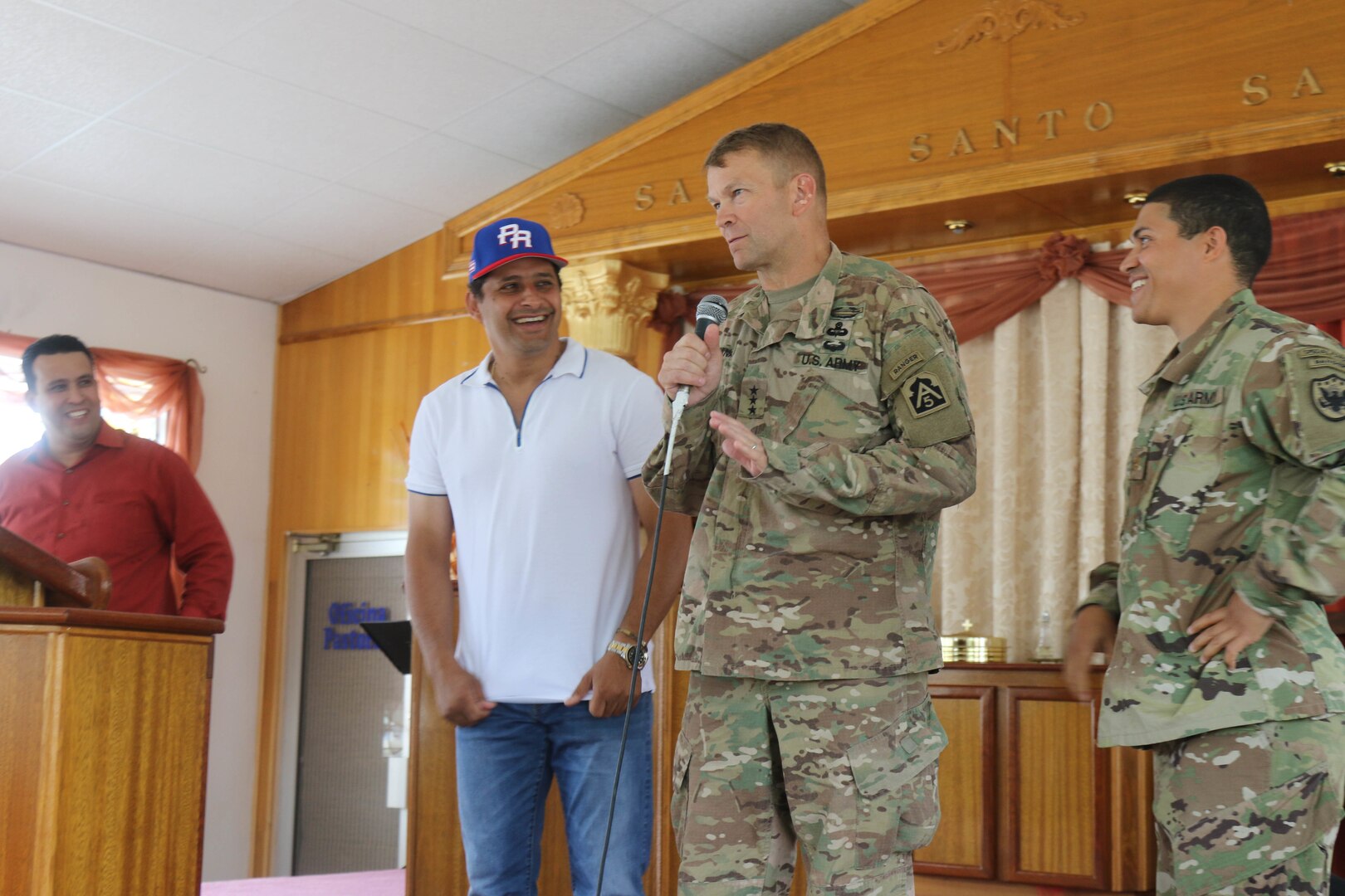 Lt. Gen. Jeffrey Buchanan breaks the ice as he introduces himself to members of a local church with Carlos Molina, mayor of Arecibo Oct. 29. Buchanan, appointed by the Pentagon to lead recovery efforts in Puerto Rico and the U.S. Virgin Islands, met with the mayor to discuss the condition of the municipality's bridges and water supply as well as ways to support residents displaced from their homes by Hurricane Maria.