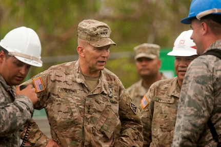 Lt. Gen. Jeffrey S. Buchanan, commander, U.S. Army North (Fifth Army) at Joint Base San Antonio-Fort Sam Houston, speaks with civil engineer Airmen from the 85th Engineering Installation Squadron, Keesler Air Force Base, Miss., at a communication tower located in the mountains of Pugnado Adentro in Vega Baja, Puerto Rico, Nov. 8, 2017. Several civil engineer Airmen were assisting local contractors repair the communication tower that works as a main communication radio hub for the island.