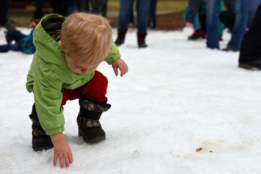 A Team Shaw child touches snow during the 20th Force Support Squadron’s Frosty Fest at Shaw Air Force Base, S.C., Dec. 17, 2017.