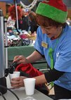 Lisa Morrison, 20th Force Support Squadron employee, prepares a drink for a guest at Frosty Fest, a family-friendly winter celebration, at Shaw Air Force Base, S.C., Dec. 17, 2017.
