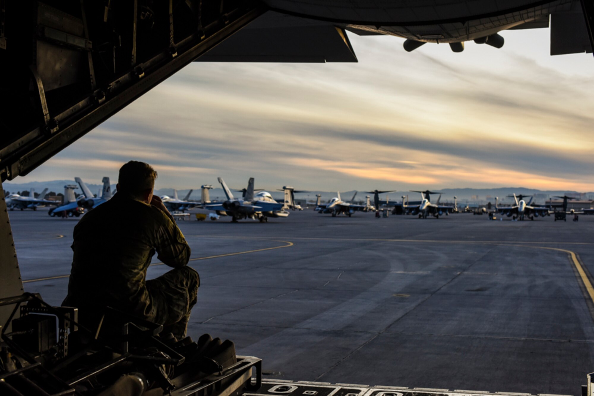 An Air Commando, assigned to the 1st Special Operations Logistic Readiness Squadron, Hurlburt Field, Florida, sits on the ramp of an MC-130H Combat Talon II, assigned to the 14th Weapons Squadron, prior to Coyote Freedom 401, Dec. 12, 2017, at Nellis AFB, Nevada. Coyote Freedom 401 is one of the USAF Weapons School’s advanced Special Operations exercise involving dozens of squadrons and aircraft from around the Air Force. (U.S. Air Force photo by Airman 1st Class Andrew D. Sarver/Released)