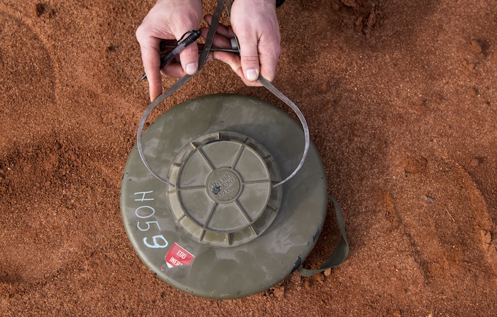 Staff Sgt. Sherwood D. Johnson IV, 628th Civil Engineer Squadron Explosive Ordnance Disposal technician takes measurements on an ordnance as part of a reconnaissance during the EOD Olympics Dec. 15, 2017.