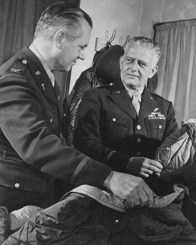 Col. Herbert B. Wright (left), the Chief of Professional Services, U.S. Army 8th Air Force and Brig. Gen. Malcolm C. Grow, at the time, Surgeon of the U.S. Army 8th Air Force, examine a heating bag Grow helped develop to keep fliers warm during high-altitude missions. (Photo courtesy of Air Force Medical Service History Office)