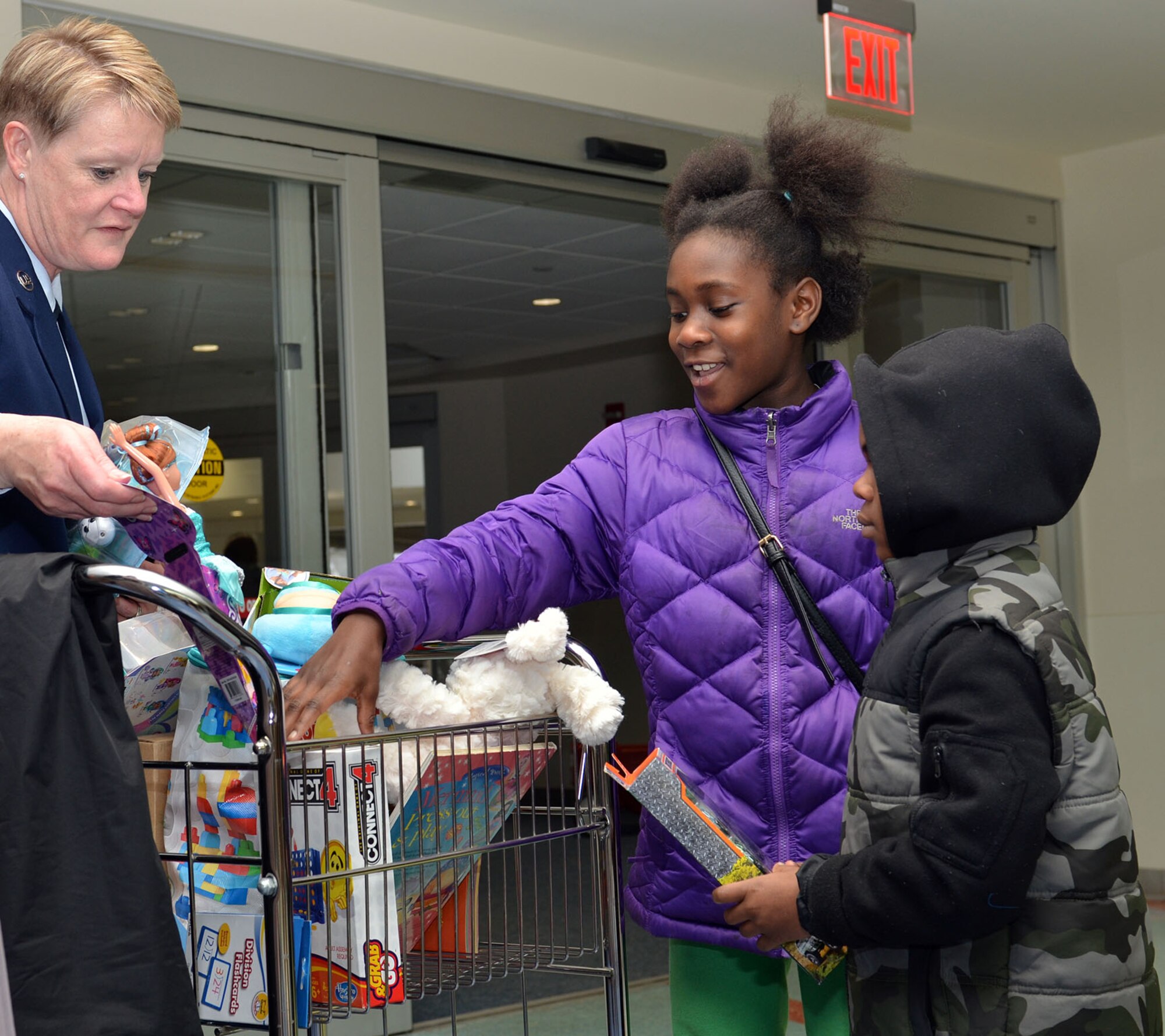 Senior Master Sgt. Linda Sparks displays the many options to two children at Dayton Children’s Hospital Dec 15, 2017.
