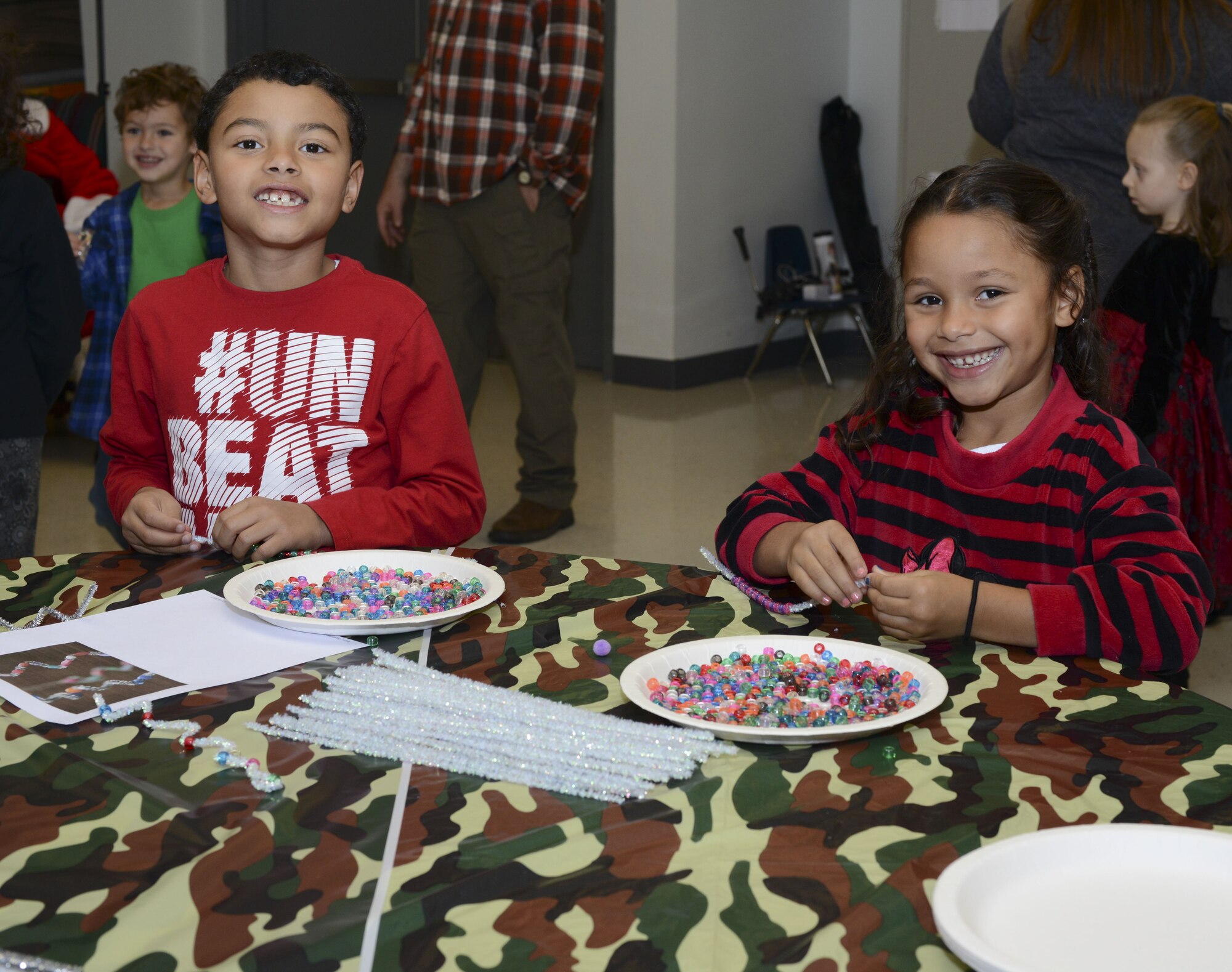 Jadyn, left, and Jazzelli Vargas, children of Michael Colvin, 23d Maintenance Squadron conventional maintenance crew chief, make crafts during a holiday party, Dec. 15, 2017, at Moody Air Force Base, Ga. The Airman and Family Readiness Center hosted the event for families of deployed or remote-tour Airmen, and families enrolled in the Exceptional Family Member Program. During the party, families enjoyed a turkey dinner, played games, made arts and crafts for their loved ones and shared a special moment with Santa Claus. (U.S. Air Force photo by Senior Airman Lauren M. Sprunk)