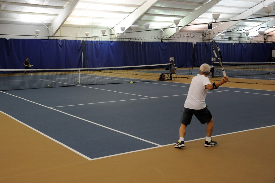 Dung Chu returns a shot to his brother, Thanh Chu at the Wright-Patterson Tennis Club, located at 4805 Skeel Ave. in Bldg. 90, Area A. (U.S. Air Force Photo/W. Eugene Barnett Jr.)