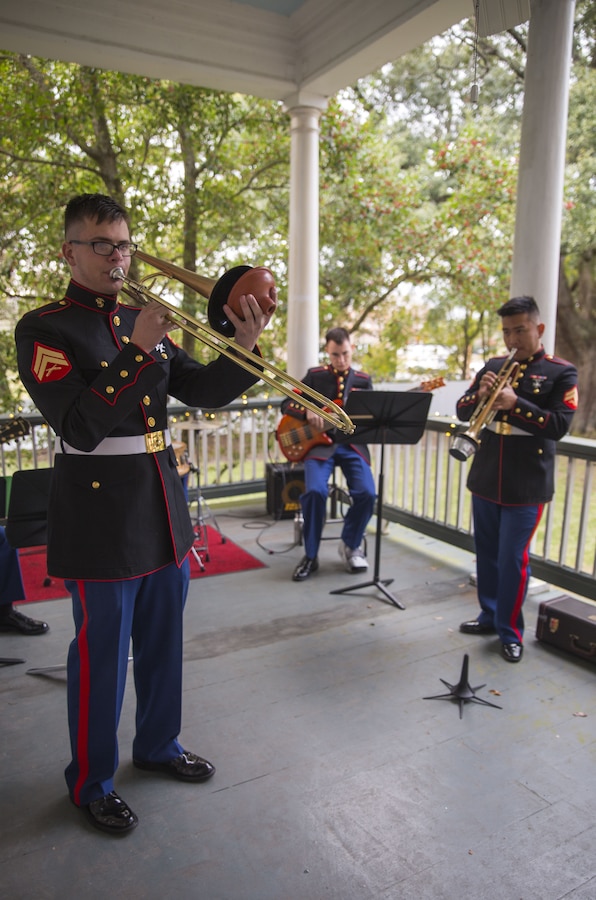 Cpl. David Linnenkamp (left), trombone instrumentalist, Cpl. Michael Choi (right), trumpet instrumentalist, and Lance Cpl. Dallin Taylor (center), electric bass instrumentalist, all with Marine Corps Band New Orleans Jazz Combo, perform holiday songs for incoming guests at an annual Christmas party hosted by Lt. Gen. Rex C. McMillian’s, commander of Marine Forces Reserve and Marine Forces North, Dec. 16, 2017. The event, hosted in the general’s quarters, allowed distinguished military guests, civilians and their families to enjoy a night of food and beverage to celebrate the holiday season. (U.S. Marine Corps photo by Sgt. Nicole Pompei / Released).