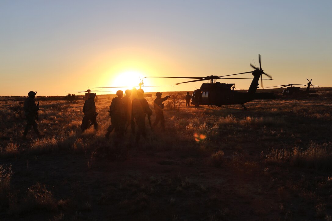 Army pilots, crew chiefs and soldiers conduct and after action review from their day and night aerial gunnery.