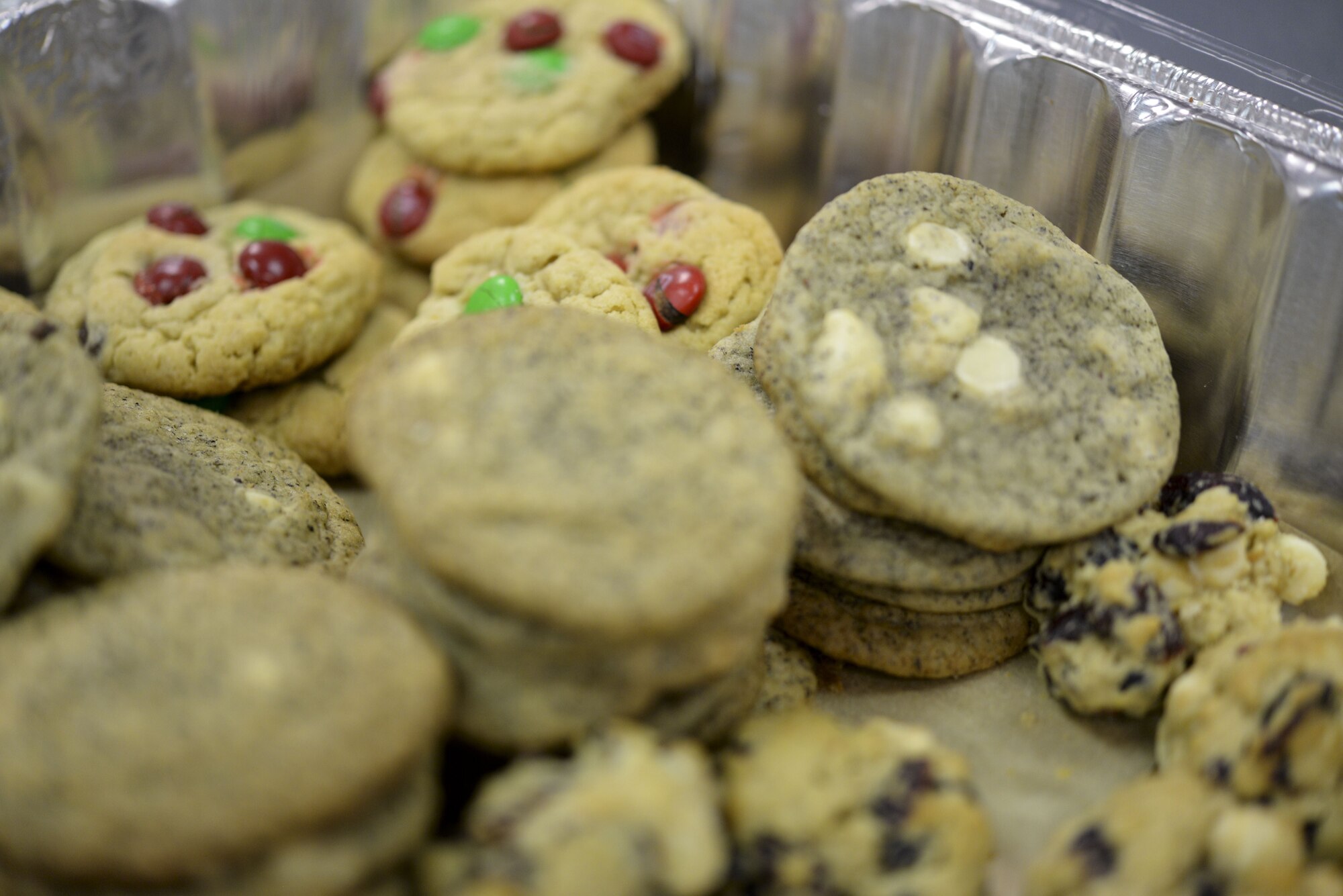 Team Dover leadership packaged a variety of donated cookies to distribute to dorm Airmen Dec. 18, 2017, during Operation Cookie Drop at the 9th Airlift Squadron on Dover Air Force Base, Del. The Dover Chiefs’ Group has organized this holiday event annually for the last fifteen years. (U.S. Air Force photo by Staff Sgt. Aaron J. Jenne)