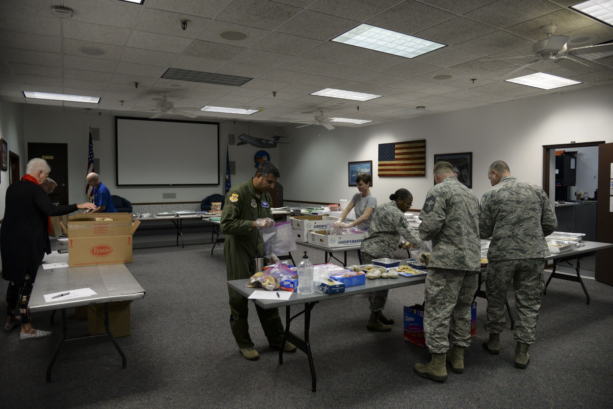 Volunteers package cookies for Team Dover Airmen who live in the dorms Dec. 18, 2017, during Operation Cookie Drop at the 9th Airlift Squadron on Dover Air Force Base, Del. More than 40 volunteers packaged donated cookies in the hopes of providing a dozen cookies to every dorm resident on Dover AFB. (U.S. Air Force photo by Staff Sgt. Aaron J. Jenne)