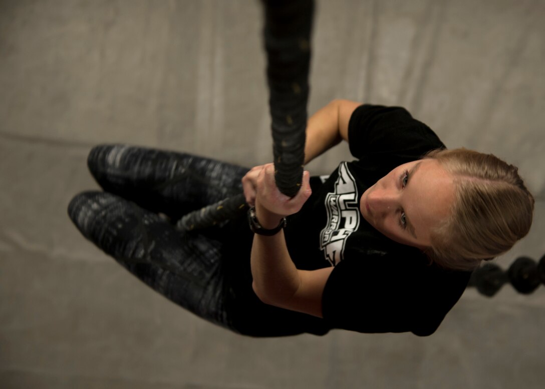 2nd Lt. Zoe Casteel, Air Force Research Lab space systems engineer, climbs a rope at the Ninja Force Gym, Albuquerque, N.M., Dec. 4. Casteel was a pole vaulter while at the Air Force Academy and all through high-school.
