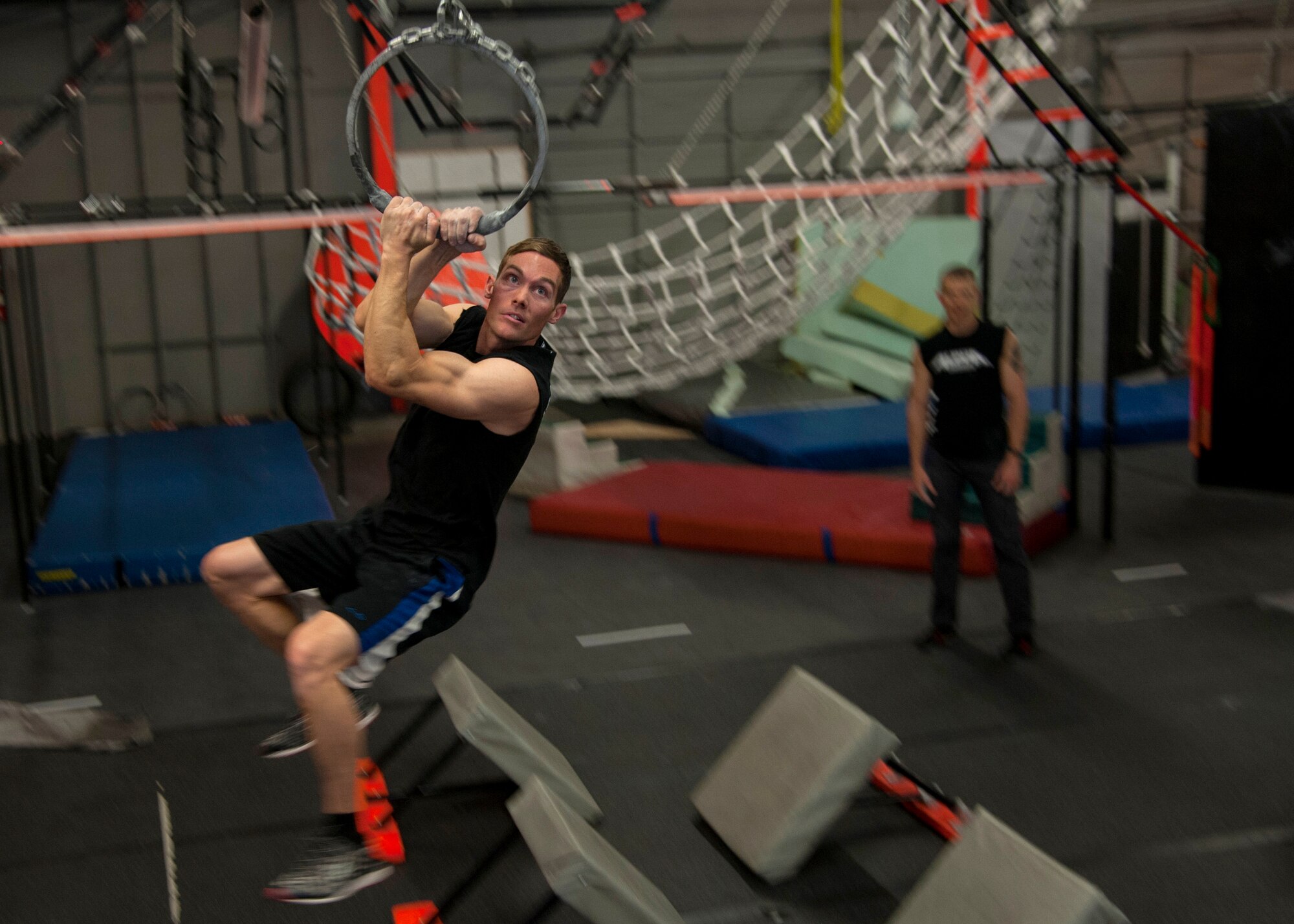 Tech. Sgt. David Krause, 58th Maintenance Squadron CV-22 “osprey” crew chief, swings on an obstacle at the Ninja Force Gym, Albuquerque, N.M., Dec. 4. Krause began his ninja obstacle training a year ago.