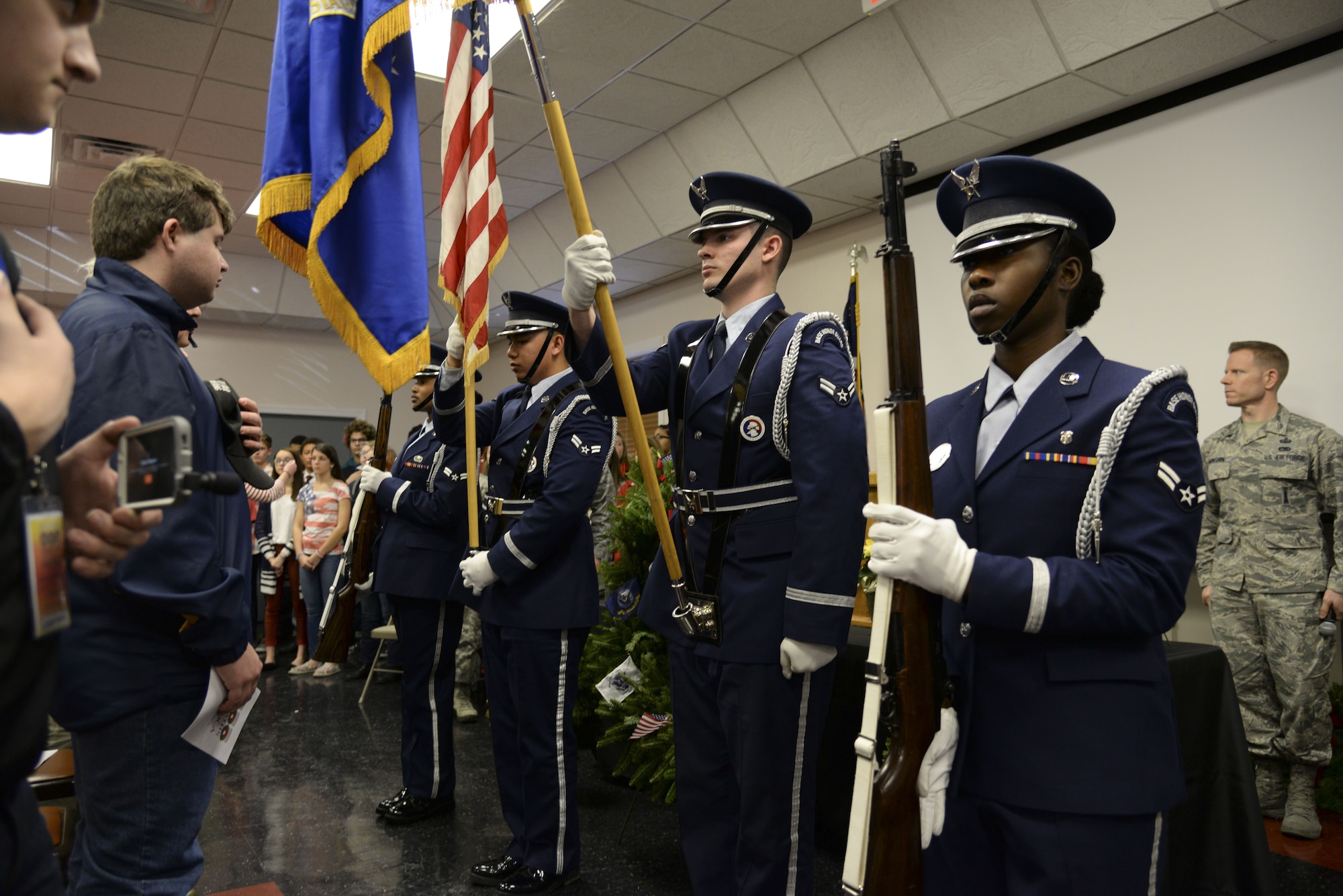 An honor guard team from Dover Air Force Base, Del., presents colors as a local children’s quartet sings the national anthem Dec. 14, 2017, at the Camden-Wyoming Fire Company. More than 150 community members gathered for the Wreaths Across America Stop Ceremony to celebrate service members, veterans, their families and their contributions to the local community. (U.S. Air Force photo by Staff Sgt. Aaron J. Jenne)
