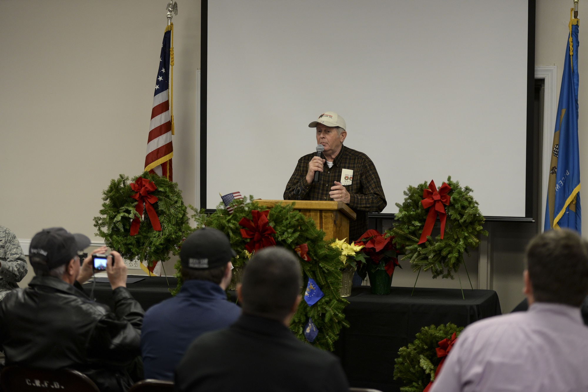 Morrill Worchester, owner of the Worcester Wreath Company and founder of the Wreaths Across America, speaks about the history of the wreath-laying movement Dec. 14, 2017, at the Camden-Wyoming Fire Company in Camden-Wyoming, Del. Worchester began Wreaths Across America in 2007 when he transported surplus wreaths to Arlington National Cemetery, Va., to honor fallen service members. The placing of wreaths has continued annually since then. (U.S. Air Force photo by Staff Sgt. Aaron J. Jenne)