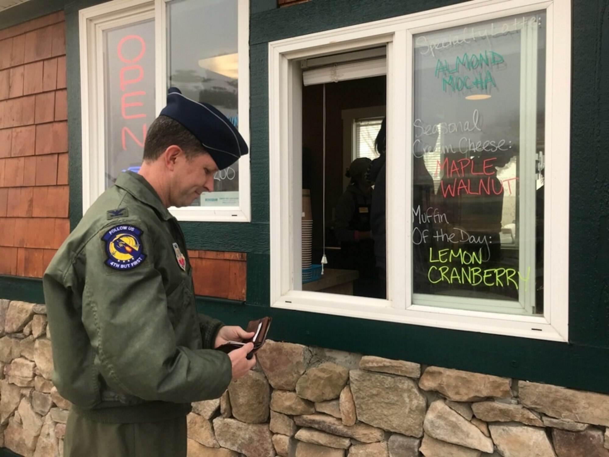 Col. Christopher Sage, 4th Fighter Wing commander, purchases the first drink at the newly opened coffee kiosk, Dec. 19, 2017, at Seymour Johnson Air Force Base, North Carolina. The coffe shop is open Monday thru Friday from 5:30 a.m. until noon. (U.S. Air Force photo by Airman 1st Class Shawna Keyes)