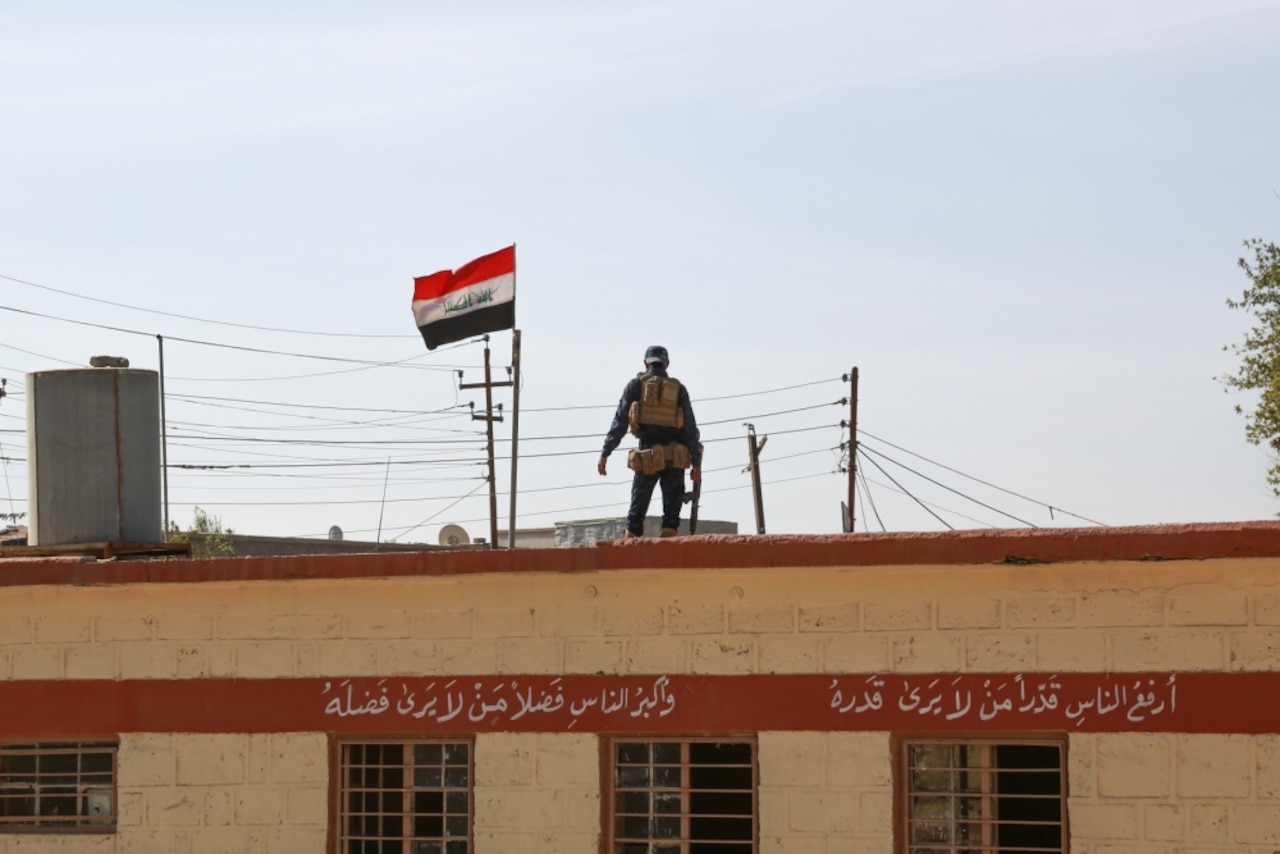 An Iraqi federal police officer provides security for students at a primary school in Aski Mosul, Iraq, Nov. 13, 2017. Army photo by Army Sgt. Tracy McKithern