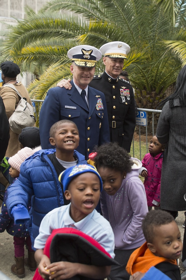 Lt. Gen. Rex C. McMillian, commander of Marine Forces Reserve and Marine Forces North, poses for a photo with U.S. Coast Guard Rear Adm. Paul Thomas, commander of Eight Coast Guard District, during the Krewe of Zulu Toys for Tots toys distribution event at the New Orleans city hall, Dec. 16,2017. The U.S. Marine Corps Reserve Toys for Tots program’s mission is to collect new, unwrapped toys during October, November and December each year and distribute those toys as Christmas gifts to less fortunate children. The program’s goal for the 2017 Christmas season is to provide toys to seven million less-fortunate children. This is the 70th anniversary season of Toys for Tots. Since its inception in 1947, the nationwide Marine Corps Reserve sponsored program has collected and distributed more than 570 million toys. (U.S. Marine Corps photo by Sgt. Ian Ferro)