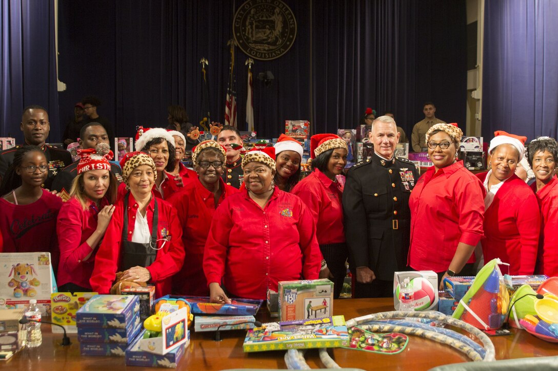 Lt. Gen. Rex C. McMillian, commander of Marine Forces Reserve and Marine Forces North, poses for a photo with volunteers with Krewe of Zulu during their Toys for Tots toys distribution event at the New Orleans city hall, Dec. 16,2017. The U.S. Marine Corps Reserve Toys for Tots program’s mission is to collect new, unwrapped toys during October, November and December each year and distribute those toys as Christmas gifts to less fortunate children. The program’s goal for the 2017 Christmas season is to provide toys to seven million less-fortunate children. This is the 70th anniversary season of Toys for Tots. Since its inception in 1947, the nationwide Marine Corps Reserve sponsored program has collected and distributed more than 570 million toys. (U.S. Marine Corps photo by Sgt. Ian Ferro)