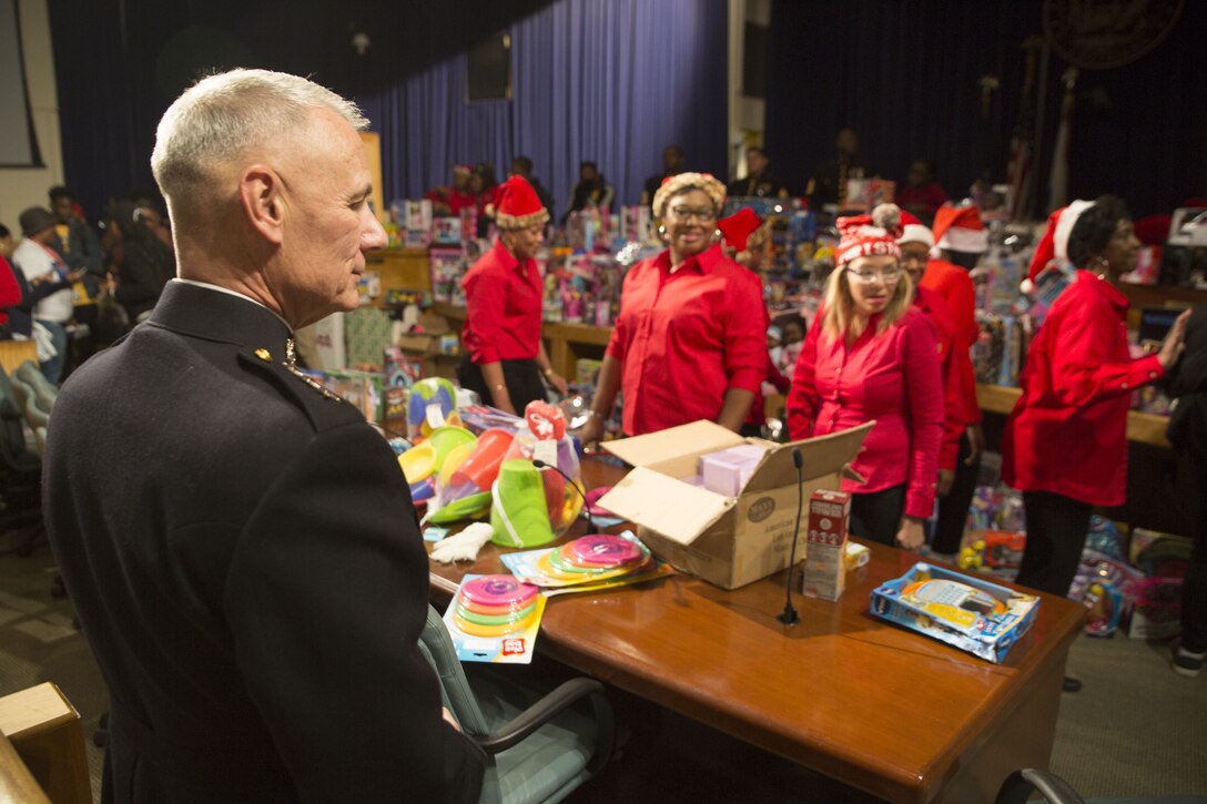 Lt. Gen. Rex C. McMillian, commander of Marine Forces Reserve and Marine Forces, North observes volunteers with the Krewe of Zulu give out toys during their Toys for Tots toys distribution event at the New Orleans city hall, Dec. 16,2017. The U.S. Marine Corps Reserve Toys for Tots program’s mission is to collect new, unwrapped toys during October, November and December each year and distribute those toys as Christmas gifts to less fortunate children. The program’s goal for the 2017 Christmas season is to provide toys to seven million less-fortunate children. This is the 70th anniversary season of Toys for Tots. Since its inception in 1947, the nationwide Marine Corps Reserve sponsored program has collected and distributed more than 570 million toys. (U.S. Marine Corps photo by Sgt. Ian Ferro)
