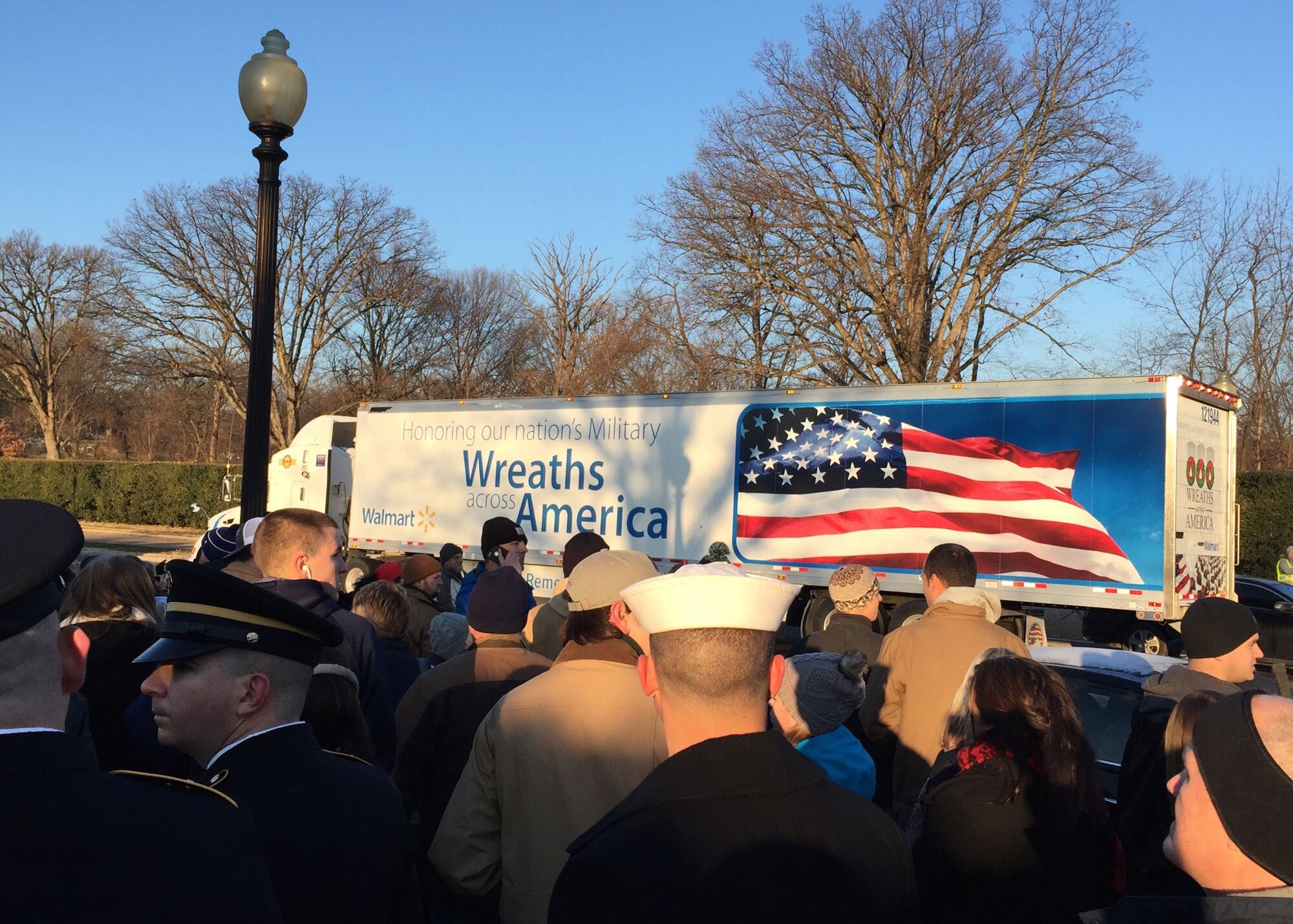 After a week’s-long journey from Harrington, Maine, to Arlington, Va., a truckload of wreaths from the Wreaths Across America convoy arrives Dec. 16, 2017, at Arlington National Cemetery. A diverse group of volunteers welcomed the wreath-carrying convoy early Saturday morning. (U.S. Air Force photo by 2nd Lt. Natasha O. Mosquera)