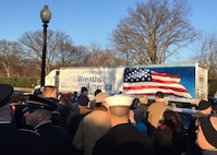 After a week’s-long journey from Harrington, Maine, to Arlington, Va., a truckload of wreaths from the Wreaths Across America convoy arrives Dec. 16, 2017, at Arlington National Cemetery. A diverse group of volunteers welcomed the wreath-carrying convoy early Saturday morning. (U.S. Air Force photo by 2nd Lt. Natasha O. Mosquera)