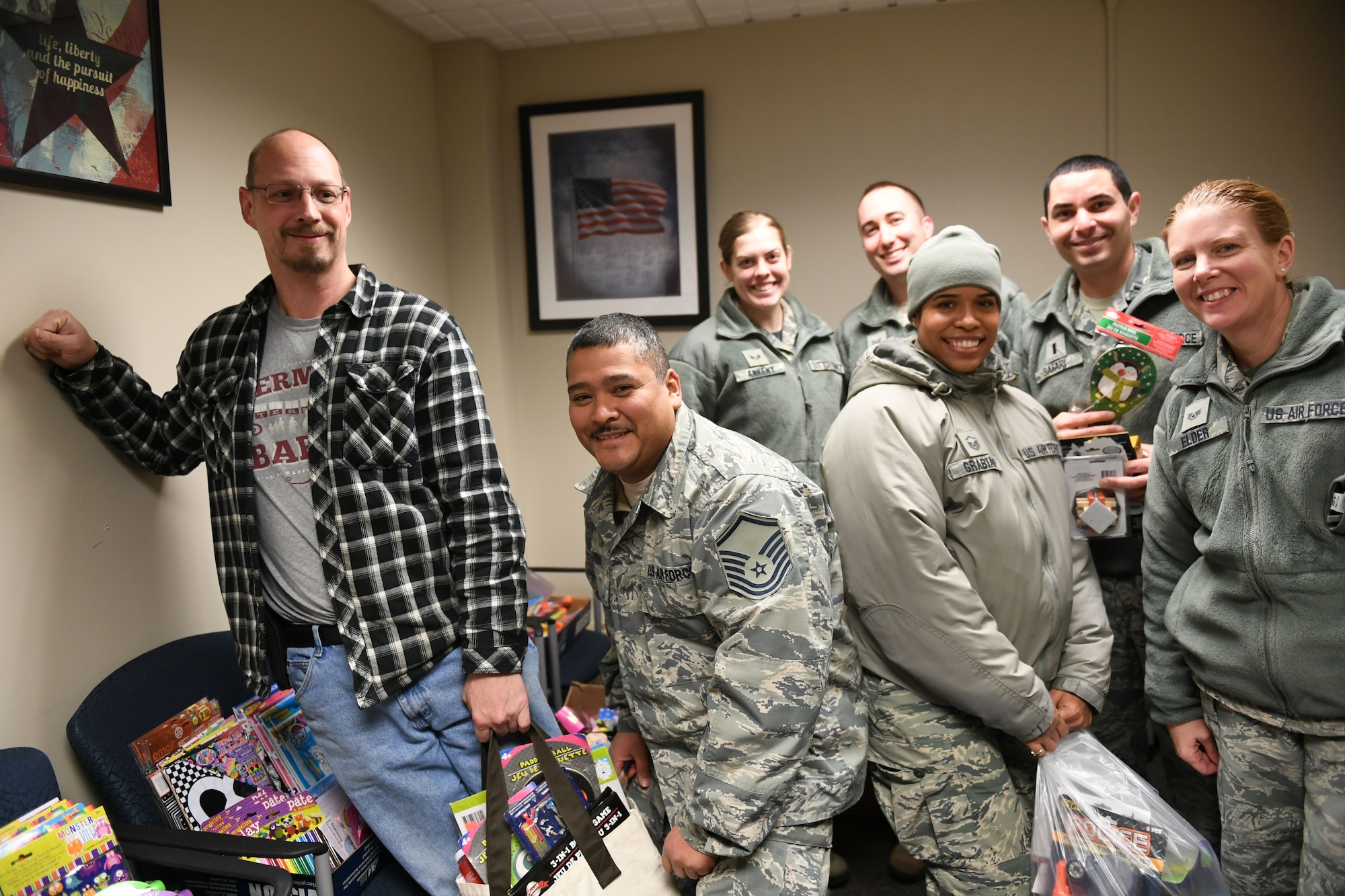 Members of the 911th Airlift Wing receive 'stocking stuffers' in preparation for the holiday season. Operation Homefront is a national nonprofit which provides relief, resiliency and family support programs to military families. (U.S. Air Force photo by Senior Airman Beth Kobily)