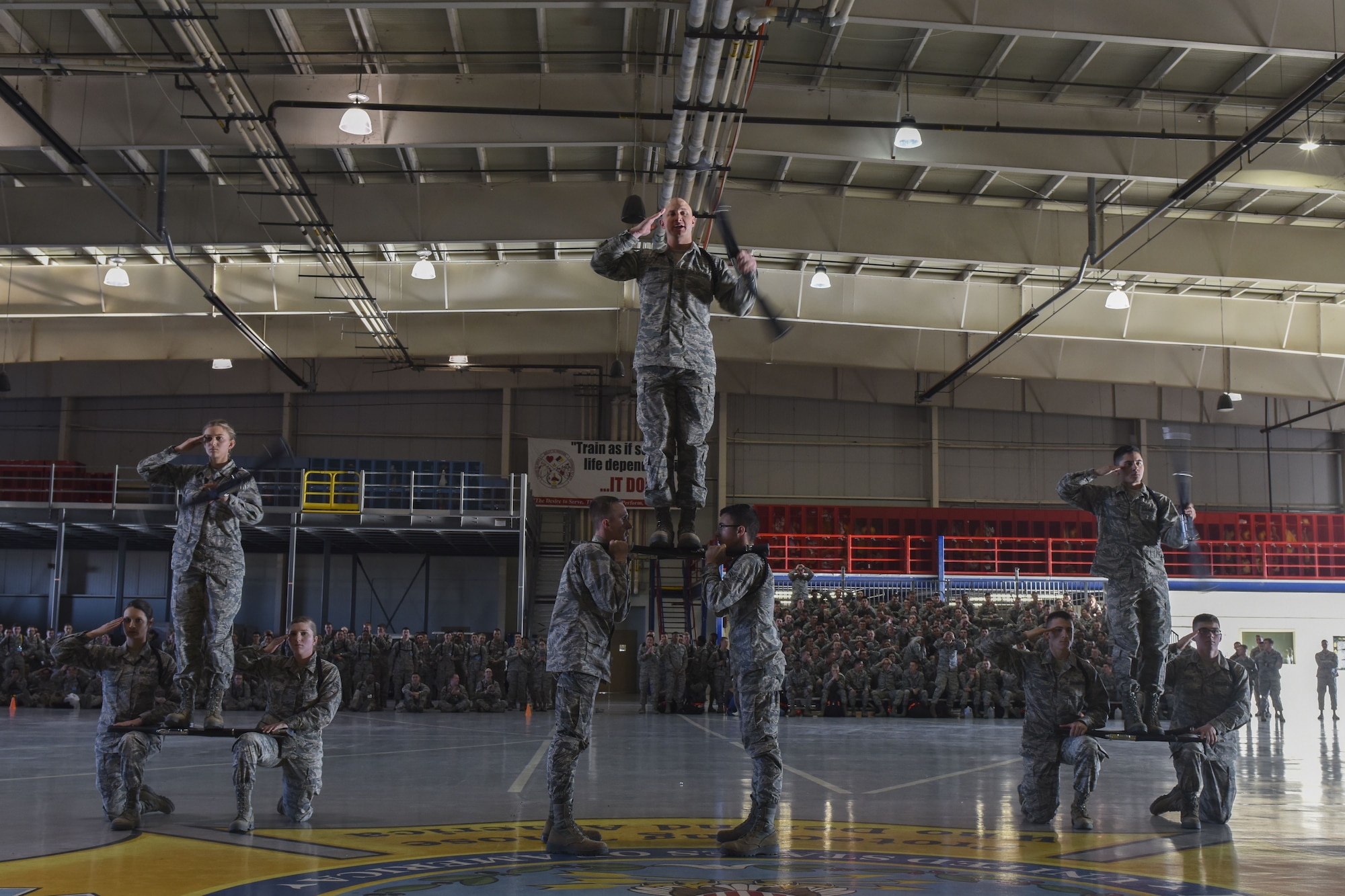 The 316th Training Squadron drill team addresses the judge at the end of their regulation drill segment during the 17th Training Group drill competition at the Louis F. Garland Department of Defense Fire Academy on Goodfellow Air Force Base, Texas, Dec. 15, 2017. The 316th TRS finished off their routine with a display of skill and balance. (U.S. Air Force Photo by Airman 1st Class Zachary Chapman/Released)