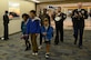 U.S. service members escort Gold Star families during the Snowball Express at Norfolk International Airport, Va., Dec. 9, 2017.