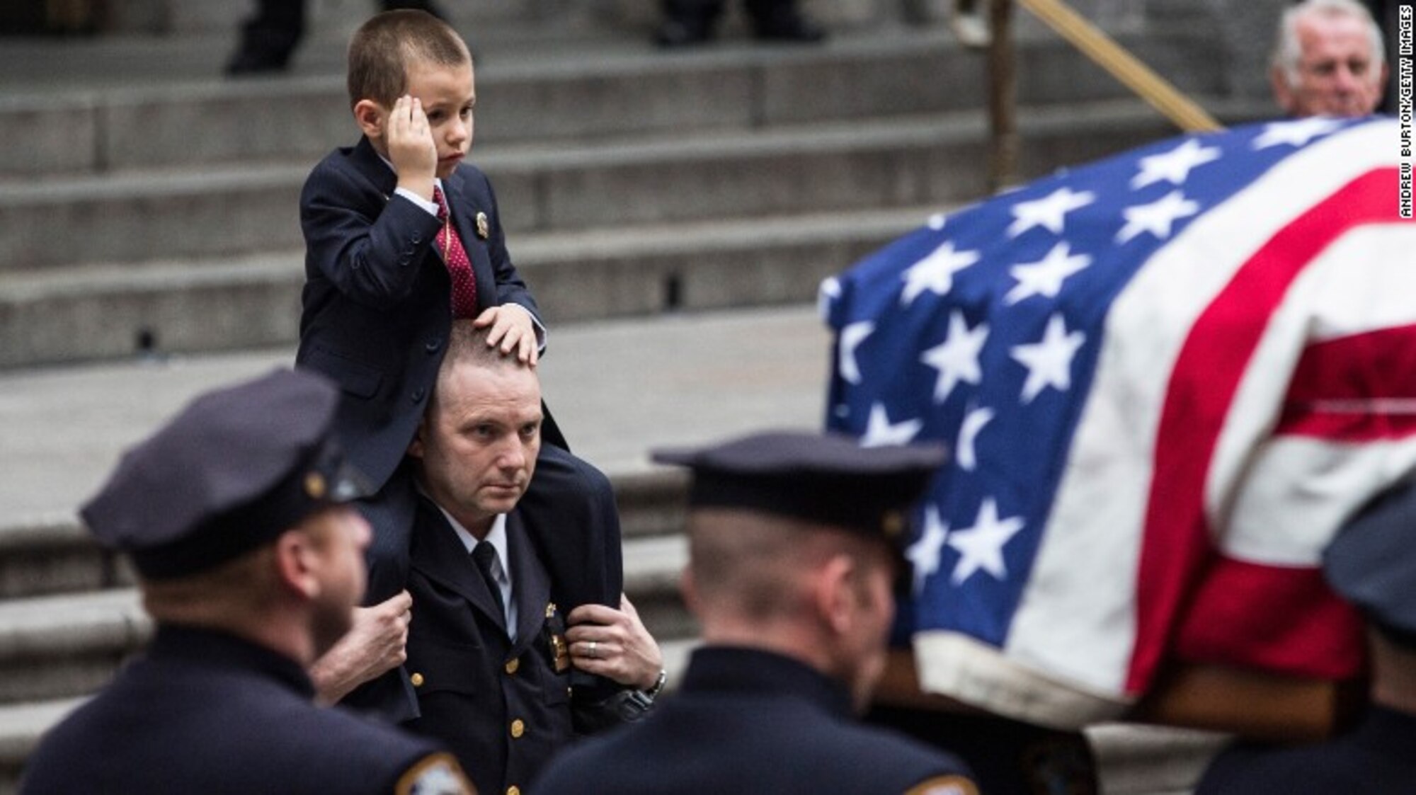 Ryan Lemm, salutes his father, Tech. Sgt. Joseph Lemm’s casket, Dec. 28, 2015, during Lemm’s funeral in Manhattan, NY. While Lemm was a member of the 105th Base Defense Squadron, the unit trains closely and often deploys with the 820th Base Defense Group. Due to the high-stress training and deployments, the lines begin to blur and these Airmen become close-knit families. (Courtesy photo)