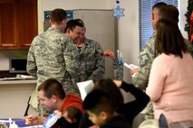 U.S. Air Force Maj. Mark Edelstein, 502nd Air Base Wing chaplain, assists Col. Jeffery Sorrell, 17th Training Wing vice commander, light one of the candles on the Menorah at Goodfellow Air Force Base, Texas, Dec. 15, 2017. Several families gathered to enjoy each other’s company, worship and hear the story of Hanukkah at the Taylor Chapel. (U.S. Air Force photo by Airman 1st class Seraiah Hines/Released)
