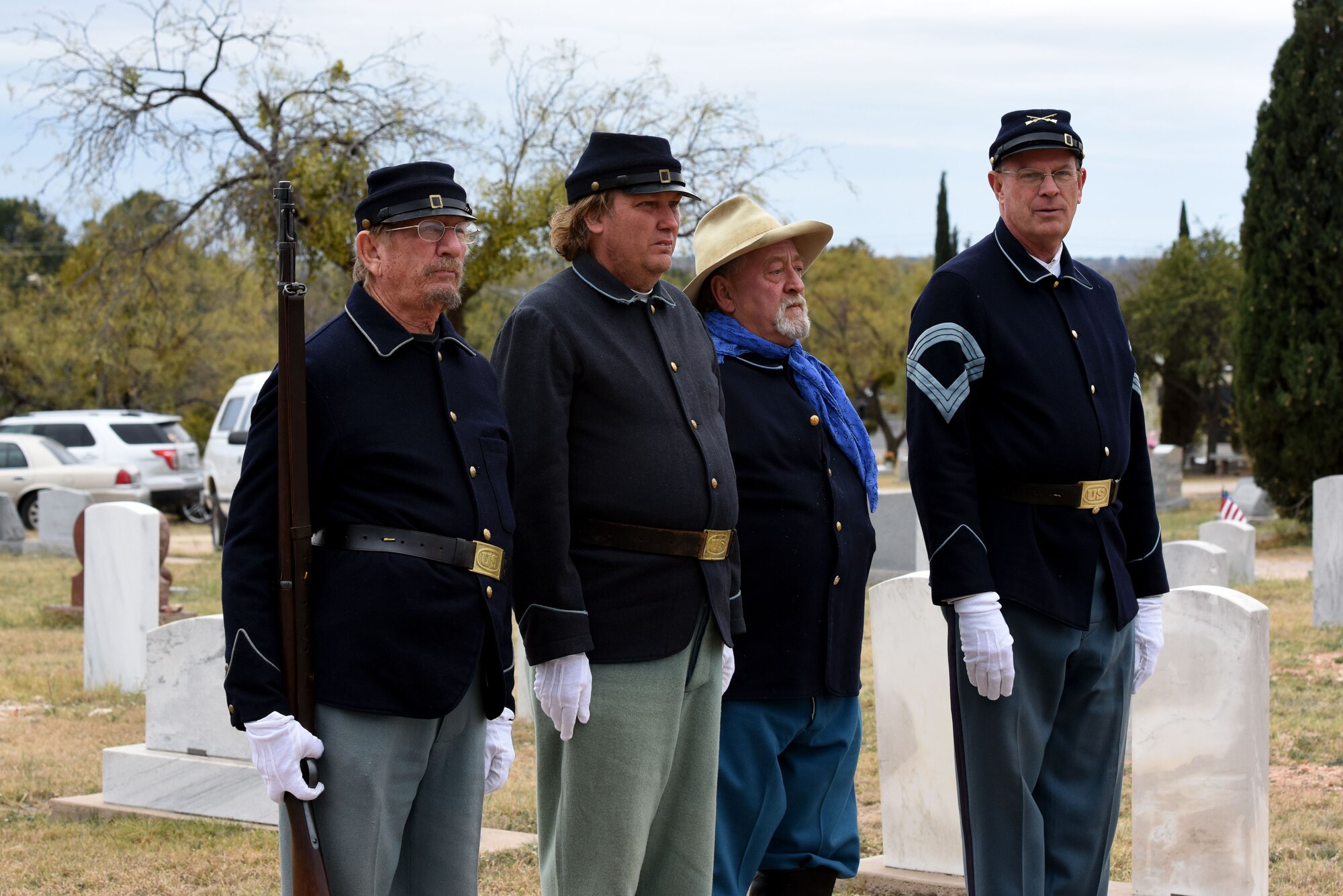 Volunteers from Fort Concho stand at attention in traditional clothing during the Wreaths Across America ceremony, at Belvedere Memorial Park, San Angelo, Texas, Dec. 16, 2017. The ceremony is held at cemeteries across the world in remembrance to those who have served our country. (U.S. Air Force photo by Airman 1st Class Seraiah Hines/Released)